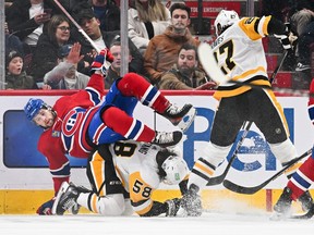 Canadiens' Josh Anderson falls over Kris Letang during first-period action at the Bell Centre Wednesday night.