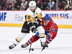 Canadiens' Brendan Gallagher reaches his stick to check Penguins Kris Letang, who has the puck, Wednesday night.