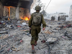 This handout picture released by the Israeli army on Friday, Dec. 22, 2023, shows a soldier operating in the Gaza Strip, amid continuing battles between Israel and the Palestinian militant group Hamas.