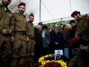 Family and friends mourn during the funeral of IDF soldier Major Shai Termin killed in a battle in south Gaza Strip on Sunday, Dec. 24, 2023. in Rosh Pina, Israel.