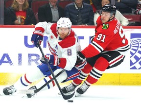 Canadiens' Mike Matheson (8)controls the puck against Anthony Beauvillier of the Chicago Blackhawks during the first period at the United Center on Friday, Dec. 22, 2023, in Chicago.