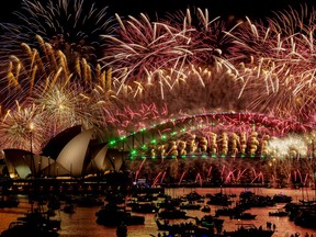 Fireworks explode over the Sydney Harbour Bridge and Sydney Opera House, left, during New Year's Eve celebrations in Sydney on Sunday, Jan. 1, 2024.