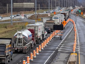 Highway traffic is narrowed to one lane using orange cones