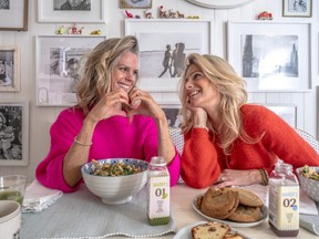 two womens in bright sweaters at the kitchen table