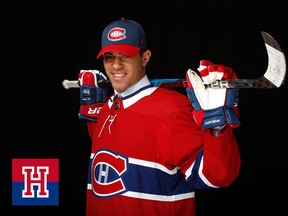 A hockey player poses with a stick over his shoulders