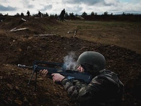 A Ukrainian soldier fires his weapon during a training exercises with French soldiers at a French military camp in France in November 2023.