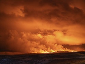 The night sky is illuminated by the eruption of a volcano in Grindavik on Iceland's Reykjanes Peninsula, Monday, Dec. 18, 2023.