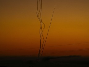 Rockets are fired toward Israel from the Gaza Strip, as seen from southern Israel, Friday, Dec. 15, 2023.