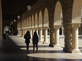 Students walk on the Stanford University campus on March 14, 2019.