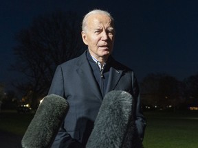 U.S. President Joe Biden answers a reporter's question as he walks from Marine One upon arrival on the South Lawn of the White House, Dec. 20, 2023, in Washington. Biden ordered retaliatory strikes Monday, Dec. 25, against Iranian-backed militia groups after three U.S. service members were injured in a drone attack in Northern Iraq.
