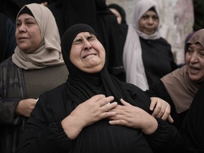 Palestinians attend a funeral of militants killed during Israeli military raid on Nur Shams refugee camp in Tulkarem, West Bank, on Sunday, Dec. 17, 2