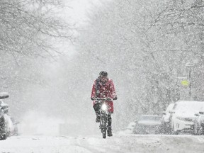 person riding a bike in the snow