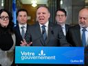 Quebec Premier François Legault speaks at a news conference marking the end of the fall session, Friday, Dec. 8, 2023 at the legislature in Quebec City. Legault is flanked by Quebec Treasury Board president Sonia Lebel, from the left, Quebec Government House Leader and Justice Minister Simon Jolin-Barrette, Quebec Education Minister Bernard Drainville and Quebec Health Minister Christian Dubé.