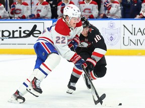 Canadiens' Cole Caufield is pressured by Sabres defenceman Henri Jokiharju during game Saturday night in Buffalo.
