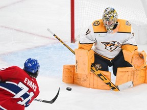 Nashville Predators goaltender Juuse Saros stops Canadiens' Jake Evans during second period NHL hockey action in Montreal on Sunday, Dec. 10, 2023.