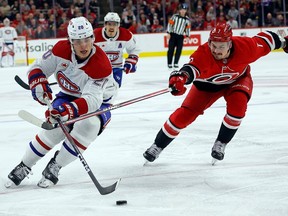 Canadiens' Juraj Slafkovsky controls the puck in front of Hurricanes' Dmitry Orlov last night in Raleigh, N.C.
