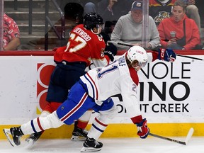 Florida Panthers' William Lockwood works for the puck against Montreal Canadiens defenceman Kaiden Guhle on Saturday, Dec. 30, 2023, in Sunrise, Fla.