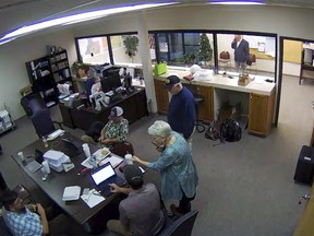 image taken from Coffee County, Ga., security video, Cathy Latham (center) is seen in the local elections office in Douglas, Ga.