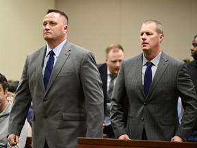 Jeremy Cooper, left, and Peter Cichuniec attend an arraignment at the Adams County Justice Center in Brighton, Colo., on Jan. 20, 2023. The two former paramedics are on trial over the 2019 death of Elijah McClain told investigators in videotaped interviews previously unseen by the public the 23-year-old Black man had "excited delirium," a disputed condition that some say is unscientific and rooted in racism.