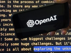 The OpenAI logo appears on a mobile phone