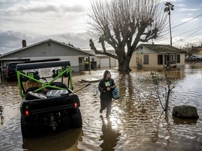 Brenda Ortega, 15, salvages items from her flooded Merced, Calif., home on Jan. 10, 2023.