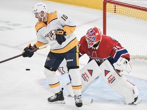 Nashville Predators' Colton Sissons tips the puck past Montreal Canadiens goaltender Jake Allen during first period NHL hockey action in Montreal on Sunday, Dec. 10, 2023.