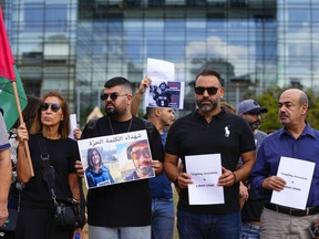 Lebanese journalists hold a portrait of Reuters videographer Issam Abdallah, right on the poster at front, who was killed by Israeli shelling, and slain Al Jazeera journalist Shireen Abu Akleh during a protest in front of the United Nations headquarters in Beirut, Lebanon, Sunday, Oct. 15, 2023.