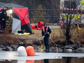 Members of the Ottawa Police Service Underwater Search and Recovery Unit conduct an underwater search on Thursday, Dec. 28, 2023.