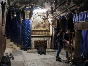 People visit the Grotto, under the Church of the Nativity, traditionally believed to be the birthplace of Jesus Christ in the West Bank town of Bethlehem, Saturday, Dec. 16, 2023.