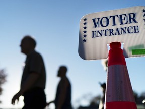 Voters pass a sign outside a polling site in Warwick, R.I., on Nov. 7, 2022.