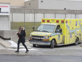 An ambulance pulls out of the emergency entrance of a hospital in Montreal, Wednesday, Dec. 29, 2021.