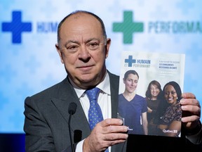 Health Minister Christian Dubé holds up a copy of Quebec's health care reform in March 2022. "When primary care doesn’t work, everything else falls apart," write Mylaine Breton and Neb Kovacina.