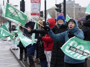 Striking health-care workers picket in front of the McGill University Health Centre superhospital on Monday, Dec. 11