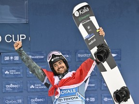 Quebecer Eliot Grondin earned bronze on Saturday, Dec. 16, 2023, in World Cup men's snowboard cross action. Grondin shown here celebrates his third-place finish at the FIS snowboard cross world cup event at Mont-Ste-Anne resort in Beaupré on March 26, 2023.