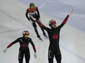 William Dandjinou of Montreal won the gold medal and fellow Quebecer Steven Dubois took the bronze in a men's 1,500-metre race at a short-track speedskating World Cup stop in Seoul. Dandjinou, right, celebrates after winning the final of the men's 1,500-metre (2) at the ISU World Cup Short Track Speed Skating Championships in Seoul, South Korea, Sunday, Dec. 17, 2023.