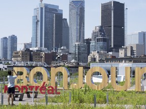 A woman takes a photo of the new Bonjour Montreal in the Old Port in Montreal on Thursday, July 6, 2023.