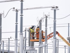 Hydro-Québec employees work on the construction site of a new substation in Montreal on Dec. 12, 2023.