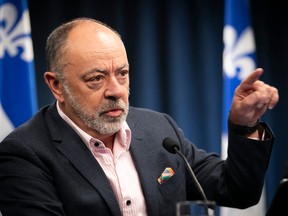 Christian Dubé gestures during a press conference.