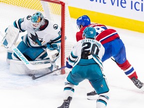 Mike Matheson on the side of the San Jose Sharks net