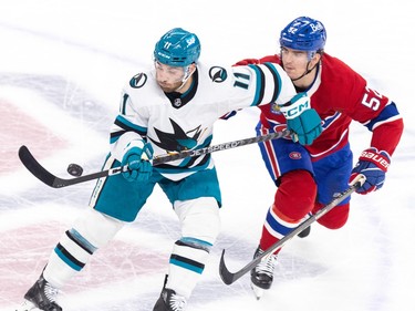 Canadiens Justin Barron watches as San Jose Sharks Luke Kunin picks the puck out of the air