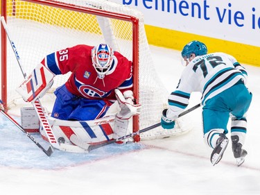 Montreal Canadiens' Sam Montembeault makes a save with his pad as Sharks' William Eklund skates by