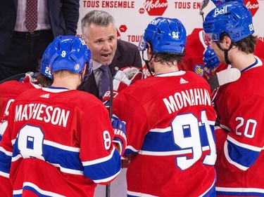 Martin St. Louis talks to Canadiens players from behind the bench
