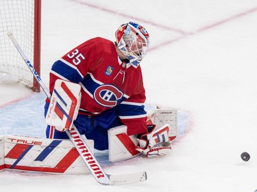 Montreal Canadiens' Sam Montembeault in nets with a puck about three feet in front of him