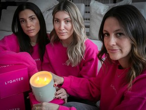 Sarah Kaplan, left, with Alexandra Toulch, centre and Tory Morton with their candle that honours the memory of their close friend, Lauren Lighter, who died last year.