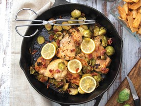 Chicken and Brussels sprouts in a cast-iron pan with lemons and bacon
