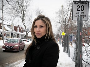 Juliana Chiovitti is seen in front of speed-limit sign near École St-Ange in St-Lambert on Wednesday, Jan. 17, 2024.