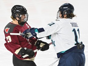 A hockey player crosschecks another on the ice.