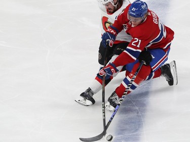 Montreal Canadiens' Kaiden Guhle handles the puck with Ottawa Senators' Zack MacEwen right behind him