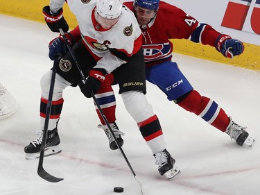 Brady Tkachuk handles the puck with Montreal Canadiens' Jayden Struble right behind him