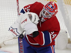 Montreal Canadiens goaltender Jake Allen crosses his glove arm across his chest with the puck just below it